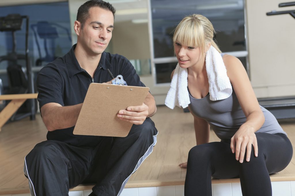 gym woman with personal trainer 