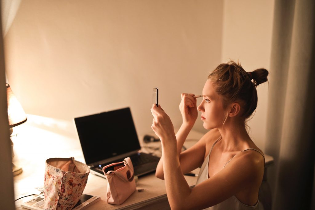 woman applying makeup