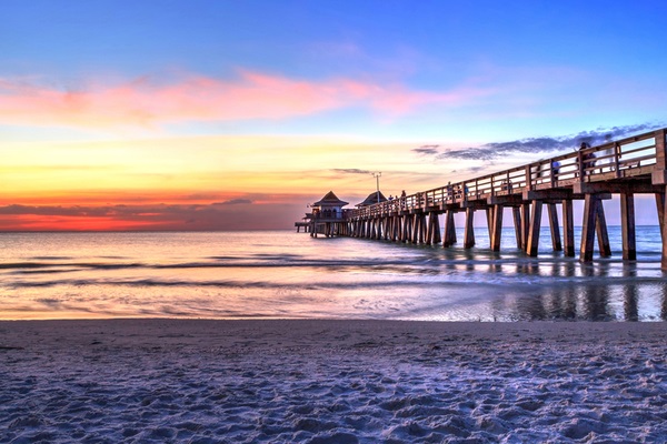 naples pier on the beach at sunset