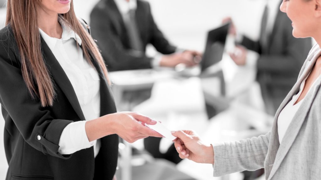 Women exchanging business cards