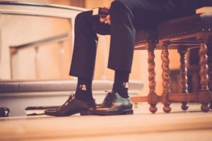 Pastor sitting on a chair holding Bible