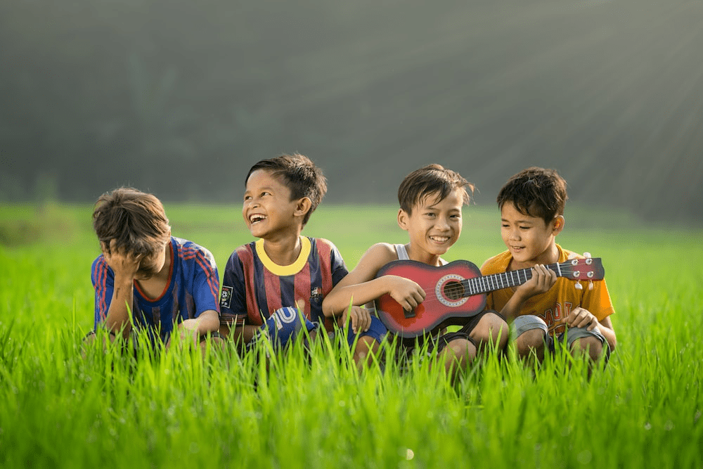 Happy children playing the guitar