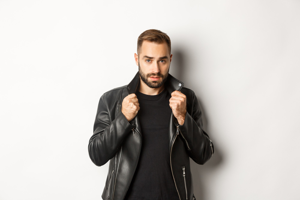 image-handsome-confident-man-putting-leather-biker-jacket-standing